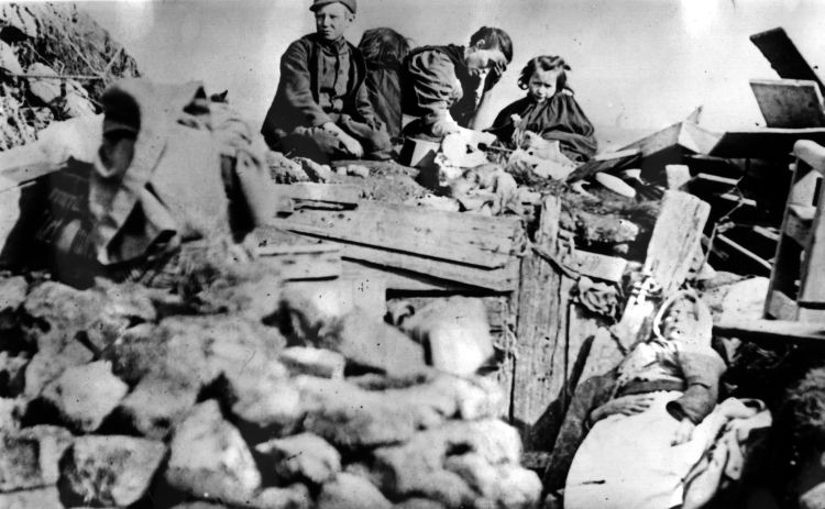 An image of an evicted Scottish family circa 1895 photographed on the ruins of their house