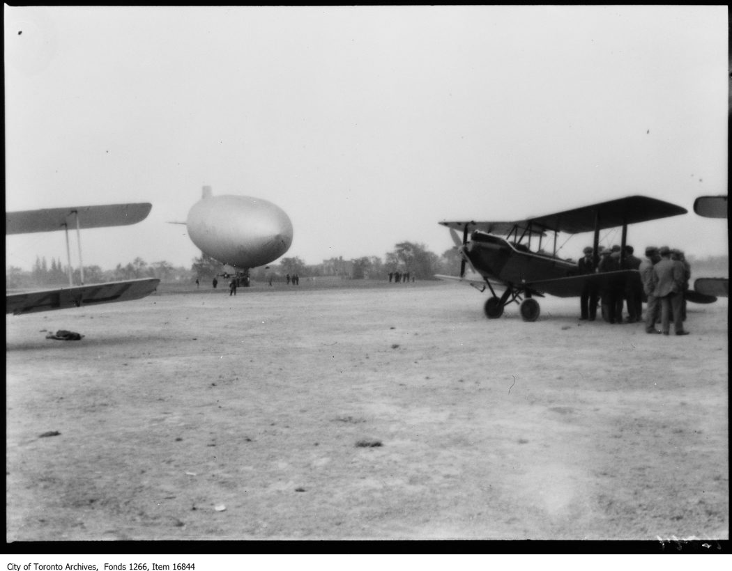 Hamilton airport, 2 planes and blimp on ground. - June 6, 1929